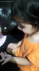 Cute Trishu putting mehndi in hand with black color