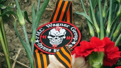 Un grupo de personas deposita flores en la sede de Wagner en San Petersburgo tras el accidente aéreo