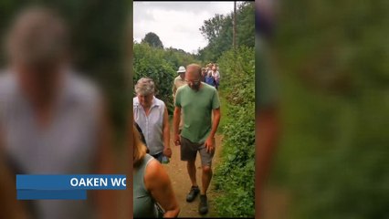 Campaigners walking through Oaken Wood to preserve the ancient woodland from further harm.