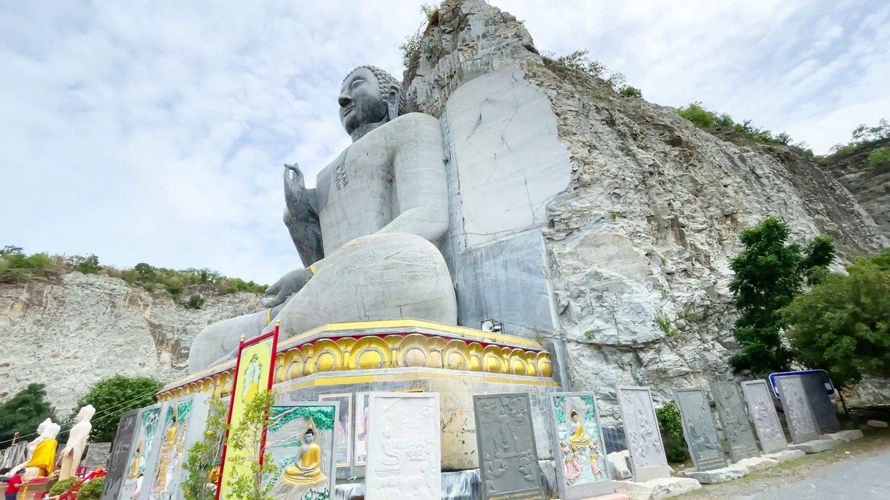 Giant Buddha Carved in Stone Wat Khao Tham Thiam at U Thong Province in Suphan Buri Thailand