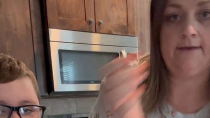 Playful mom cracks an egg on son's forehead and is delighted by his reaction