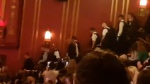 Crowd cheers as police escort Grease theatregoers from audience in London