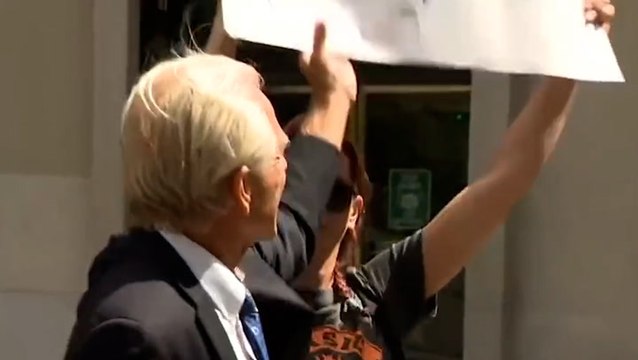 Former Trump advisor Peter Navarro attempts to snatch ‘Trump lost’ sign from protester