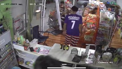 Motorcyclist with toddler on his lap crashes through glass shopfront