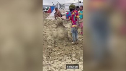 Burning Man revellers build mud sculptures and wade through dirt as thousands stranded after floods