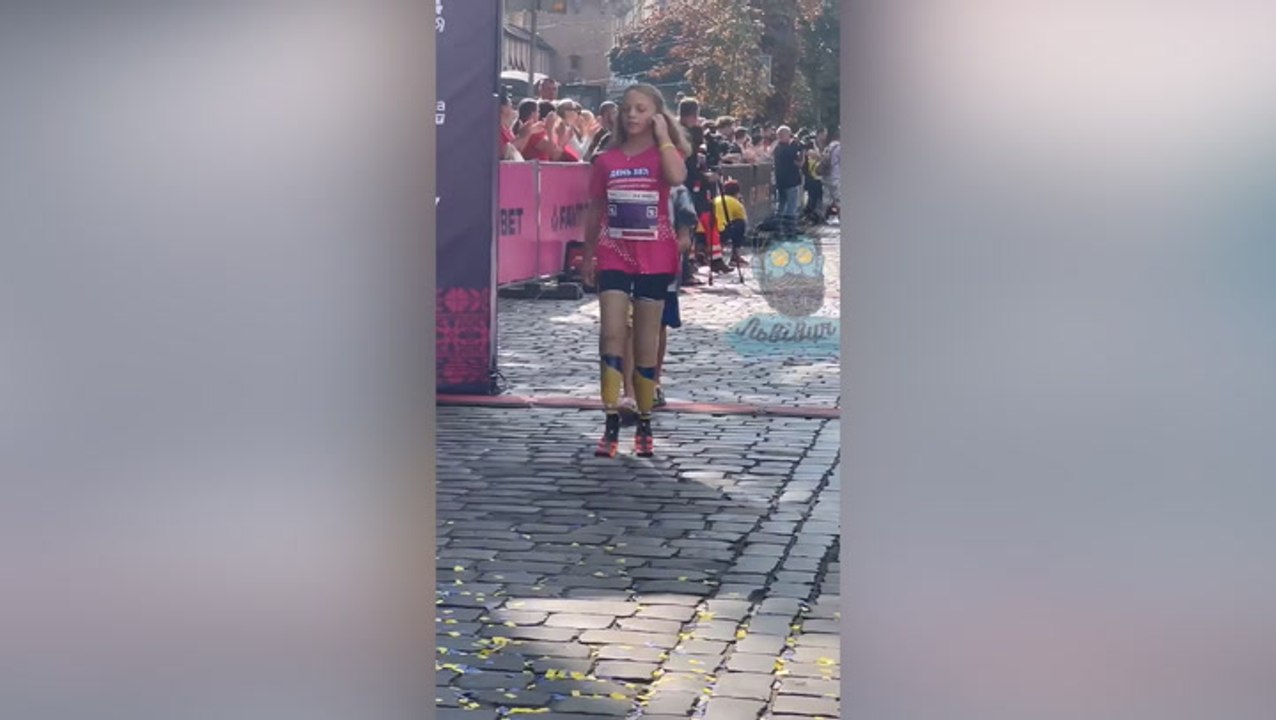 Moment Ukrainian girl, 12, who lost both legs in Russian missile attack completes half marathon