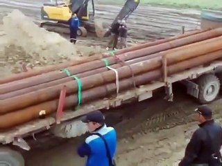 Big load truck felling into the river 