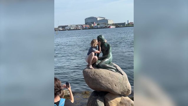 Tourist booed as she climbs Copenhagen’s Little Mermaid statue despite warnings