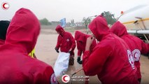 Libyan aid workers help residents navigate waist-deep water