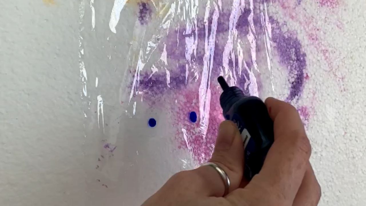 Artist creates a beautiful butterfly-wing pattern on a vase using paints and cling wrap