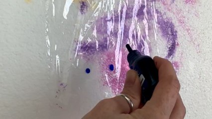 Artist creates a beautiful butterfly-wing pattern on a vase using paints and cling wrap