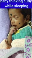 Baby thinking cutely while sleeping