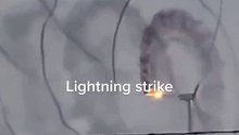 Electrifying Moment: Lightning Strikes Windmill in Spectacular Display!