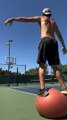 Guy Dribbles Ball and Makes Multiple Basketball Trickshots While Balancing Himself on Exercise Ball