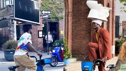 Only in NYC! Onlookers Confused as Man Balances Random Objects on His Head