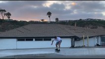 Skateboarder Successfully Executes Roof Jump Trick After Failing Twice