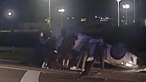 ‘Good samaritans’ help police officers lift flipped car to save trapped driver