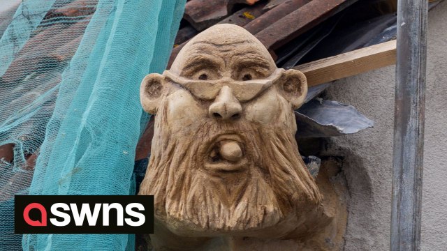 Fuming builder puts stone gargoyle of local official on his roof as planning row turns ugly