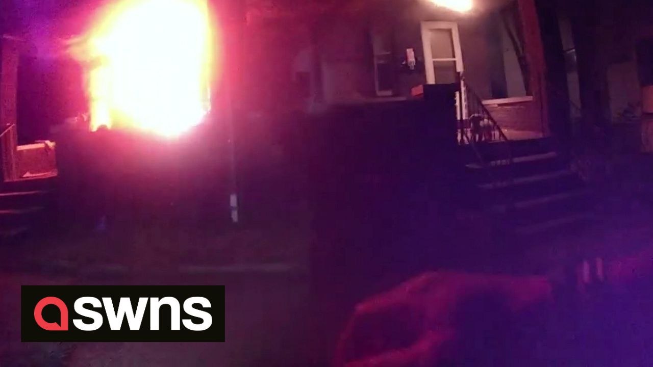Police officer responding to another call rush towards burning house to rescue residents