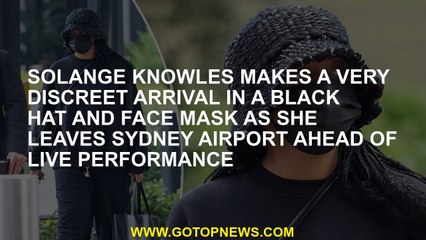 Solange Knowles makes a very discreet arrival in a black hat and face mask as she leaves Sydney Airp