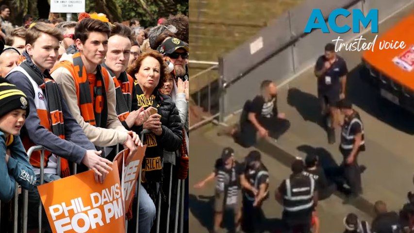 Climate protesters from Extinction Rebellion disrupt AFL Grand Final parade in Melbourne, wearing 'can't play footy in 50 degrees' shirts before being removed by security.