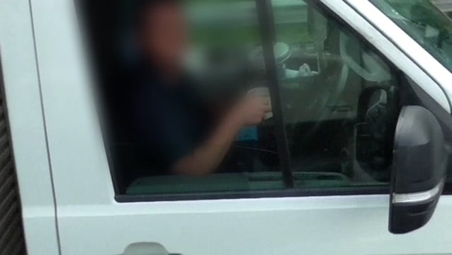 Truck driver takes both hands off steering wheel to drink cup of tea on M6