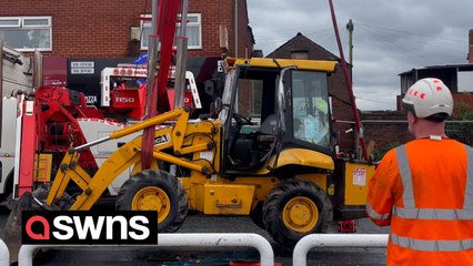 Man seriously hurt after becoming "trapped" under digger that fell from lorry