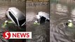 Motorist rescued after getting stuck in flood waters at Jalan Chan Sow Lin