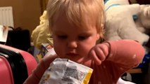 Baby girl's face lights up with joy after she finds a crisp in an 'empty' pack