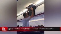 Uçakta bavulunu yerleştirmekte zorlanan adamın komik anları