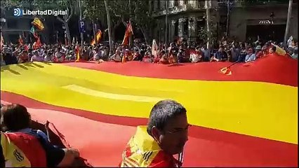 Una enorme bandera de España es desplegada al inicio de la manifestación de Barcelona