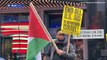 Fury as Palestinian protester waves a SWASTIKA at anti-Israel rally in New York City's Times Square as thousands of demonstrators take to the streets across the US - while rockets and gunfire flies in the Middle East