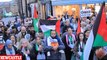 Israel and Palestine supporters are separated by police at London Tube station as thousands of pro-Palestine protesters light flares and chant outside Israel's embassy - while weeping Israelis gather in Downing Street for vigil