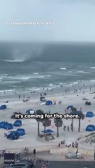 Footage captures waterspout ripping through crowded beach #Shorts