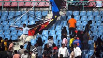 Scary moment cricket fans run for cover after stadium hoardings fall in India during Australia's World Cup clash with Sri Lanka