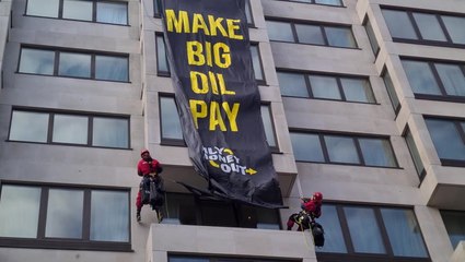 Climate activists abseil down luxury London hotel to unfurl oil protest banner