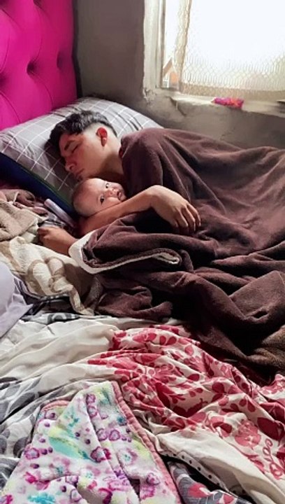 Sleeping Dad Cuddles Infant Daughter