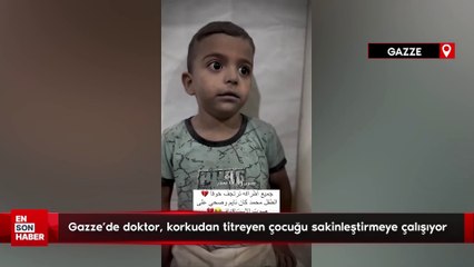 Gazze'deki doktor, korkudan titreyen çocuğu sakinleştirmeye çalışıyor