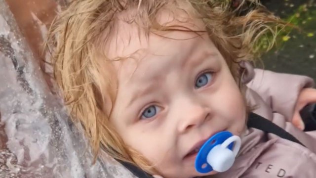 Mother finds her toddler's head out of the rain cover the whole rainy trip *Hilarious*