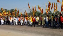 Pedestrians carrying religious flags leaving from Pinan for Mehandipur