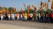 Pedestrians carrying religious flags leaving from Pinan for Mehandipur