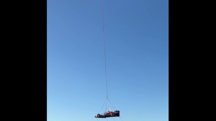 Red Bull reveals Texas-inspired livery for US GP flying car over Austin attached to a helicopter
