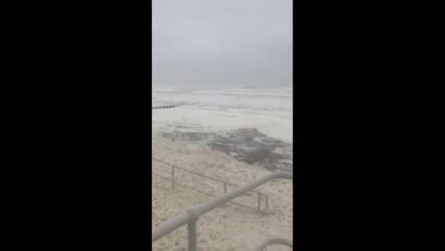 Sea foam blankets beach in Scotland as Storm Babet brings powerful winds