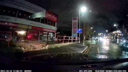 Driver speeds through traffic lights and smashes into Manchester car dealership