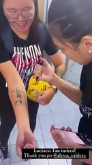 Alyssa Valdez signs tattoo of fan