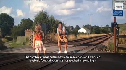 Shocking videos show reckless parents encouraging their kids to play and pose for selfies on busy railway line