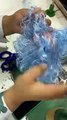 Doll Gets Blue Hair Sewn On