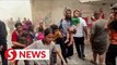 Children, families seen escaping site of airstrike in Gaza
