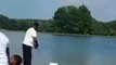 Boy pushes his father on crutches into lake