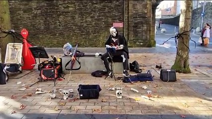 Skeleton playing Leaving On A Jetplane
